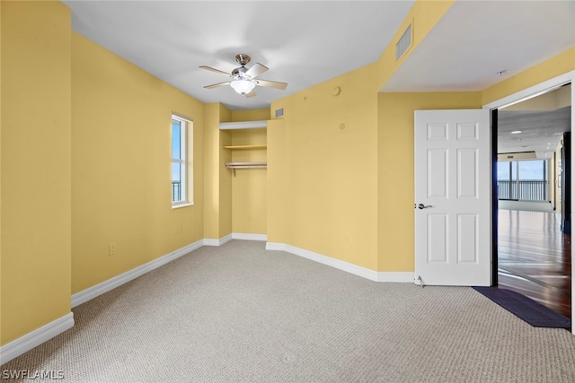 carpeted empty room featuring ceiling fan