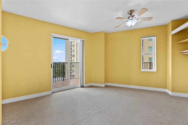 unfurnished room featuring carpet floors, baseboards, and ceiling fan