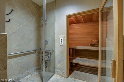 bathroom featuring tile patterned floors and a shower with door