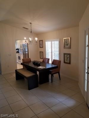 dining area featuring a chandelier and tile flooring