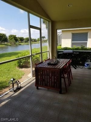 unfurnished sunroom featuring a water view