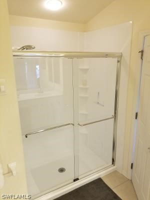 bathroom featuring tile flooring and walk in shower