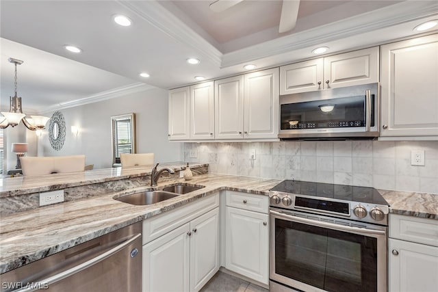 kitchen with decorative light fixtures, ceiling fan, white cabinetry, and stainless steel appliances