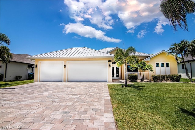 ranch-style house featuring a garage and a front lawn