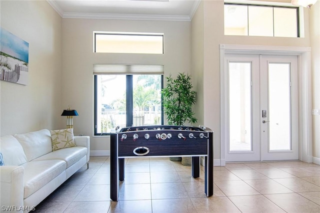 game room featuring light tile patterned floors, crown molding, and french doors