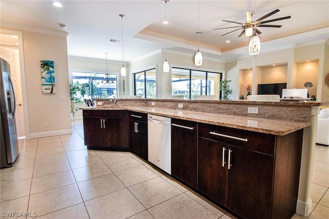 kitchen with a large island with sink, stainless steel appliances, a raised ceiling, and dark brown cabinets