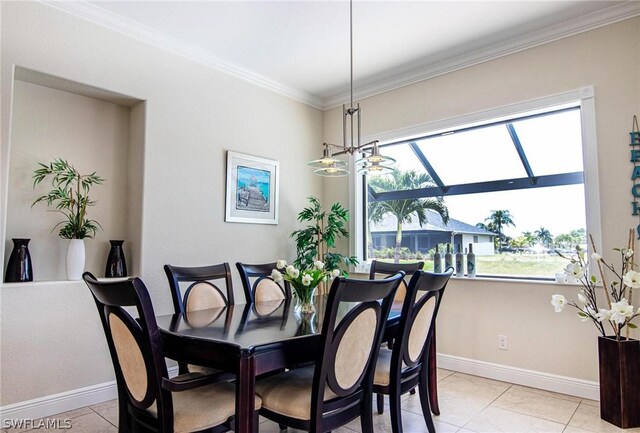 tiled dining room with a chandelier and ornamental molding