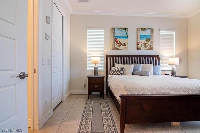 bedroom featuring crown molding and light tile patterned floors