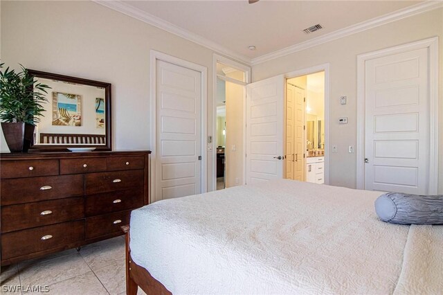 bedroom featuring light tile patterned floors, ensuite bath, and crown molding