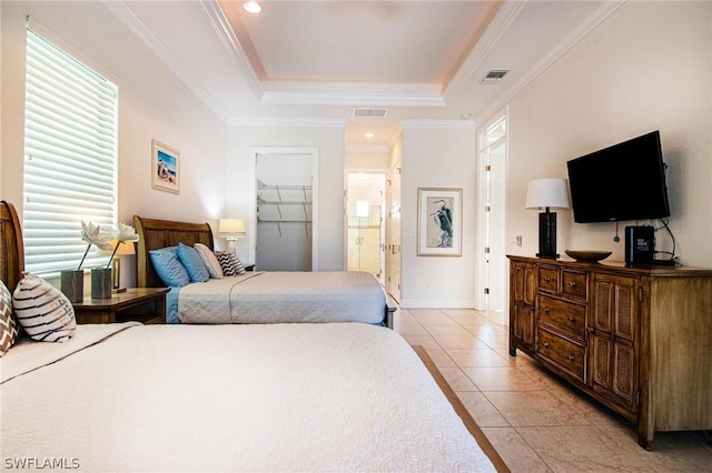 bedroom with ornamental molding, a raised ceiling, a spacious closet, a closet, and light tile patterned flooring