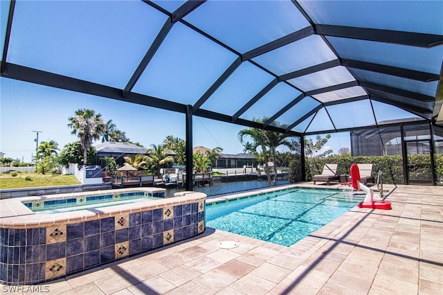 view of pool featuring an in ground hot tub, a water view, a patio area, and a lanai