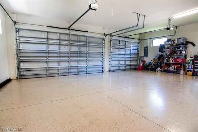 garage featuring electric panel and a garage door opener