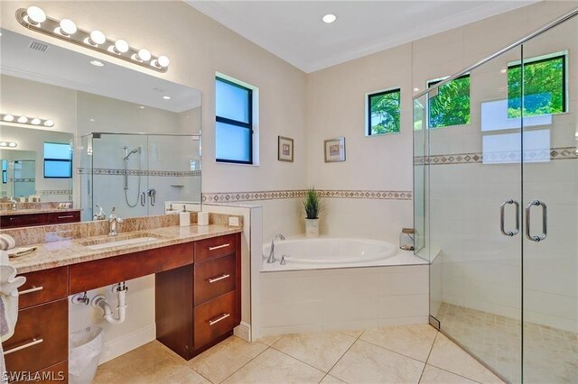 bathroom with tile patterned flooring, vanity, and separate shower and tub