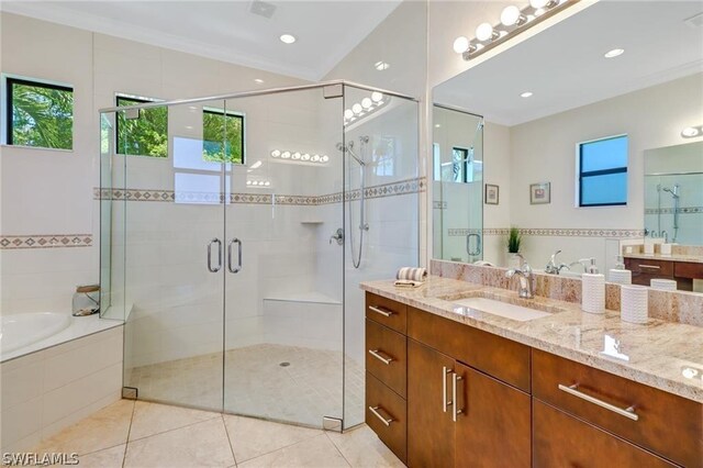 bathroom featuring tile patterned flooring, vanity, and separate shower and tub