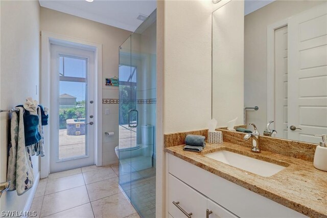 bathroom featuring tile patterned flooring, vanity, and toilet