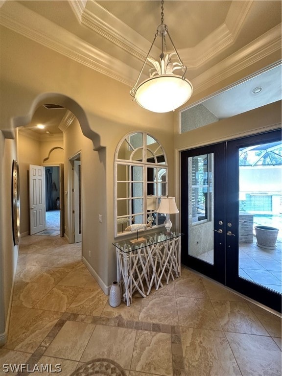 interior space featuring french doors, tile floors, and a raised ceiling