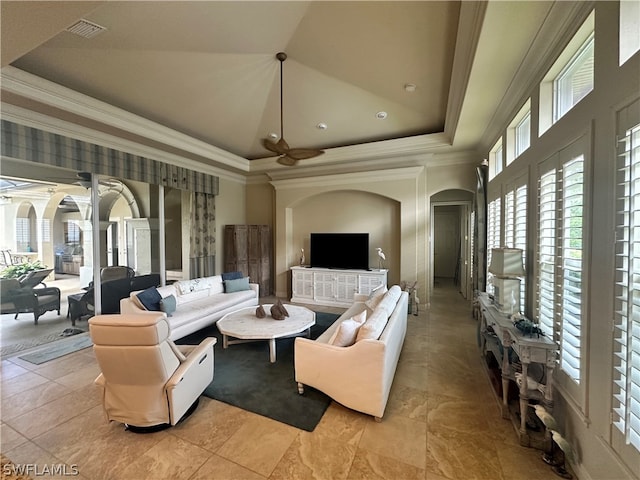 living room with a healthy amount of sunlight, light tile floors, and a tray ceiling