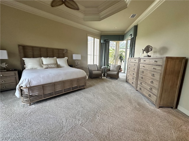 carpeted bedroom with a raised ceiling, ceiling fan, and crown molding