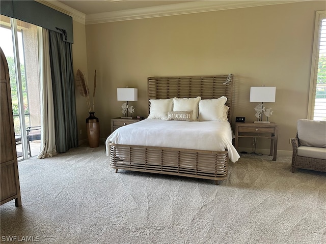 bedroom with carpet floors, crown molding, and access to outside