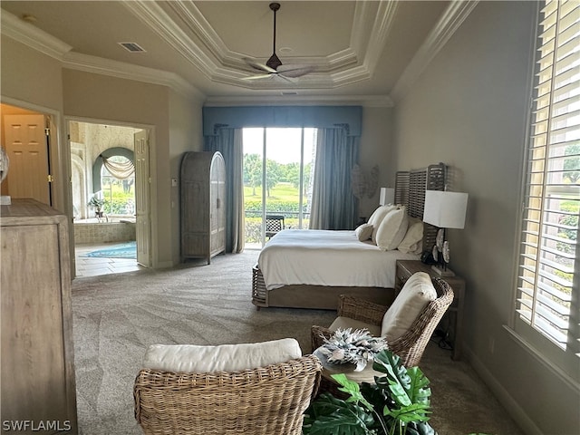 carpeted bedroom with ornamental molding, multiple windows, a raised ceiling, and access to exterior