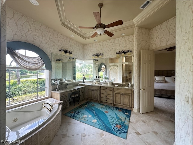 bathroom with ceiling fan, vanity with extensive cabinet space, a tray ceiling, tile floors, and dual sinks