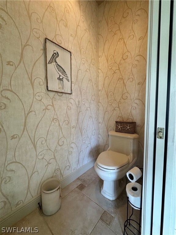 bathroom with toilet and tile floors