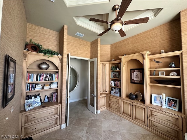 office area with tile flooring, ceiling fan, crown molding, and a raised ceiling