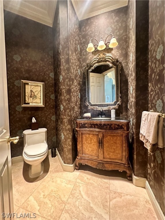 bathroom featuring tile floors, oversized vanity, crown molding, and toilet