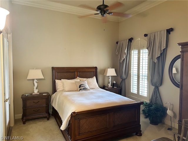 carpeted bedroom with ornamental molding and ceiling fan