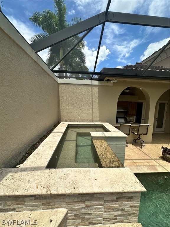 view of pool with a patio and a lanai