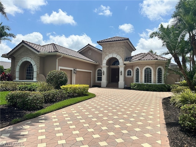 mediterranean / spanish house with a garage