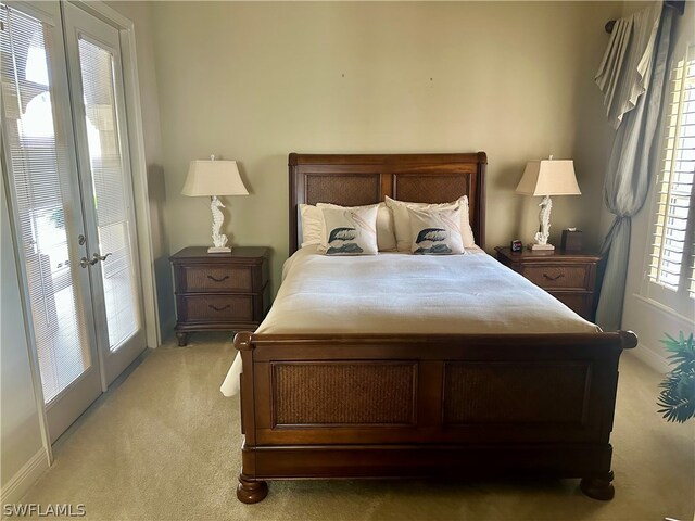 carpeted bedroom with french doors and access to outside