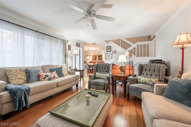 living room with crown molding, ceiling fan, and dark hardwood / wood-style floors