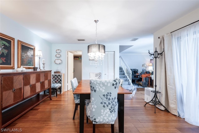 dining room featuring an inviting chandelier and hardwood / wood-style floors