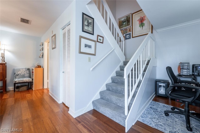 home office featuring ornamental molding and hardwood / wood-style flooring