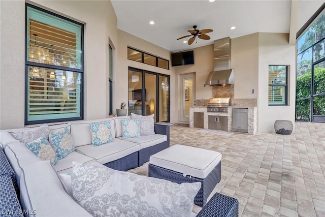 view of patio / terrace with a grill, outdoor lounge area, ceiling fan, and an outdoor kitchen