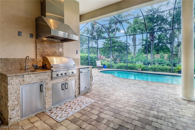 view of patio with an outdoor kitchen, a grill, a lanai, and sink