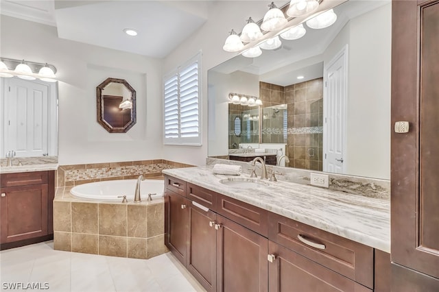 bathroom featuring tile patterned flooring, shower with separate bathtub, and vanity