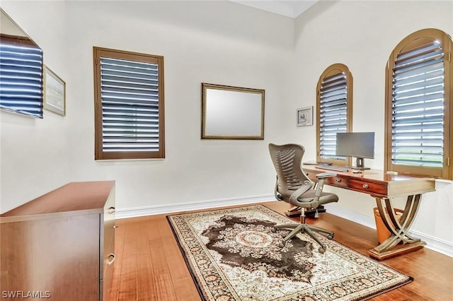 office area with hardwood / wood-style floors