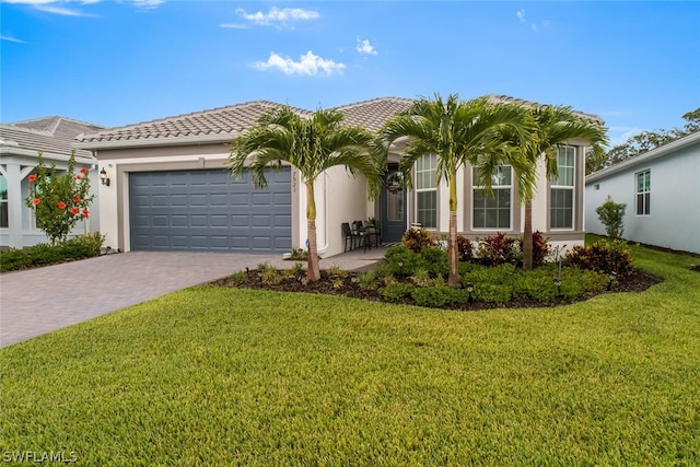 view of front of home featuring a garage and a front lawn