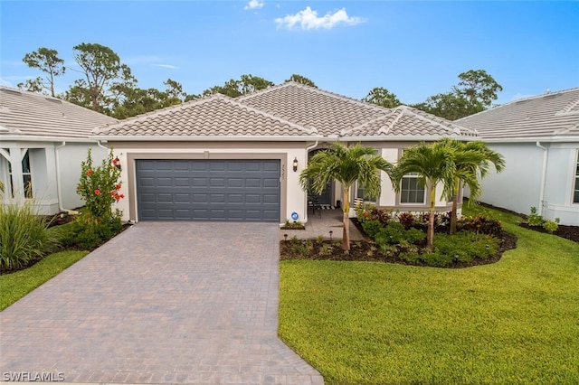 mediterranean / spanish-style house with a front lawn and a garage