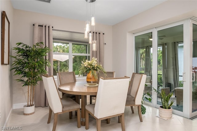 dining room featuring ceiling fan and light tile floors