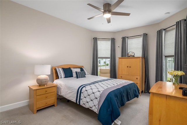 bedroom featuring ceiling fan and carpet