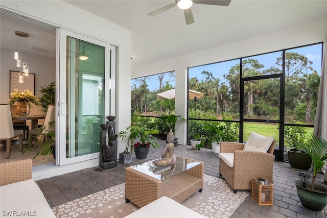 sunroom / solarium featuring ceiling fan