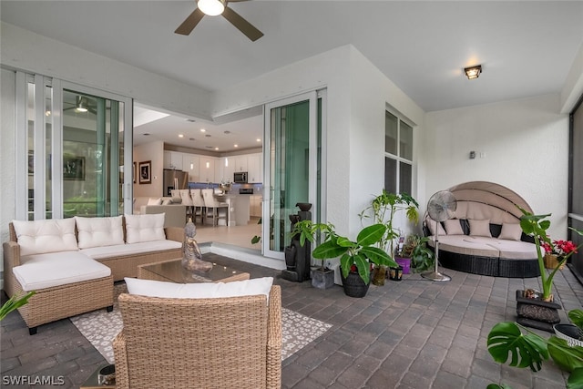 view of terrace featuring ceiling fan and an outdoor hangout area