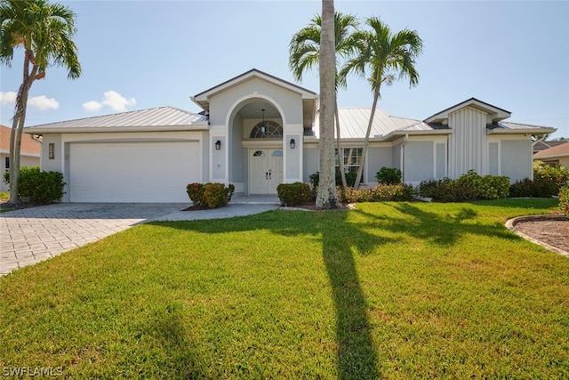 single story home with a garage and a front yard