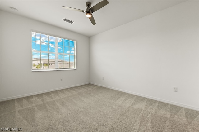 carpeted spare room with ceiling fan