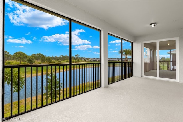 unfurnished sunroom with a water view