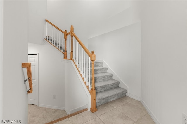 staircase with light tile floors