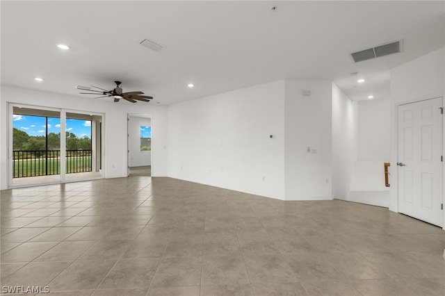 spare room featuring ceiling fan and light tile flooring